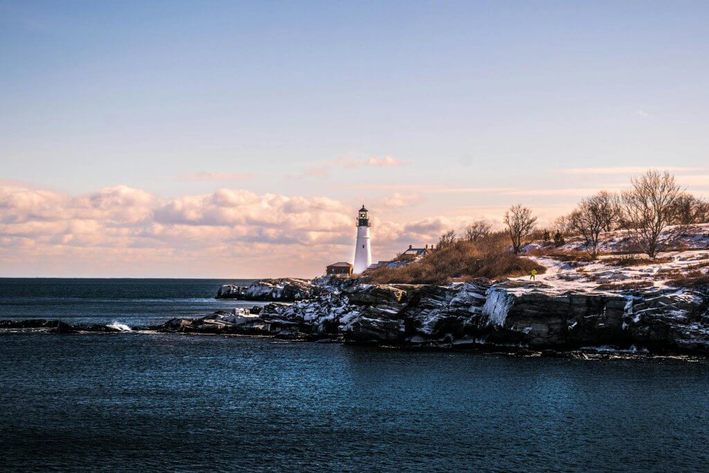 lighthouse in maine with snowfall